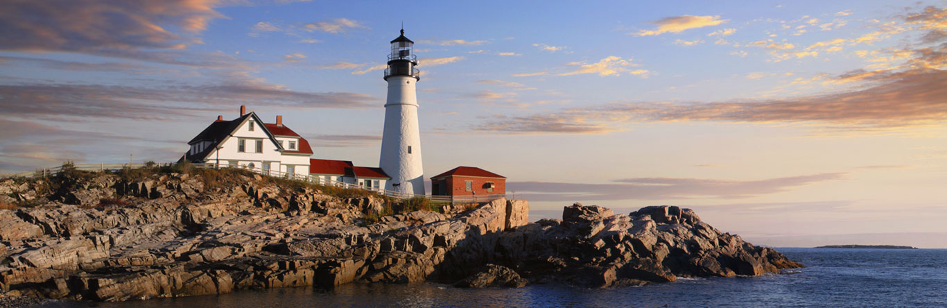 white lighthouse next to ocean