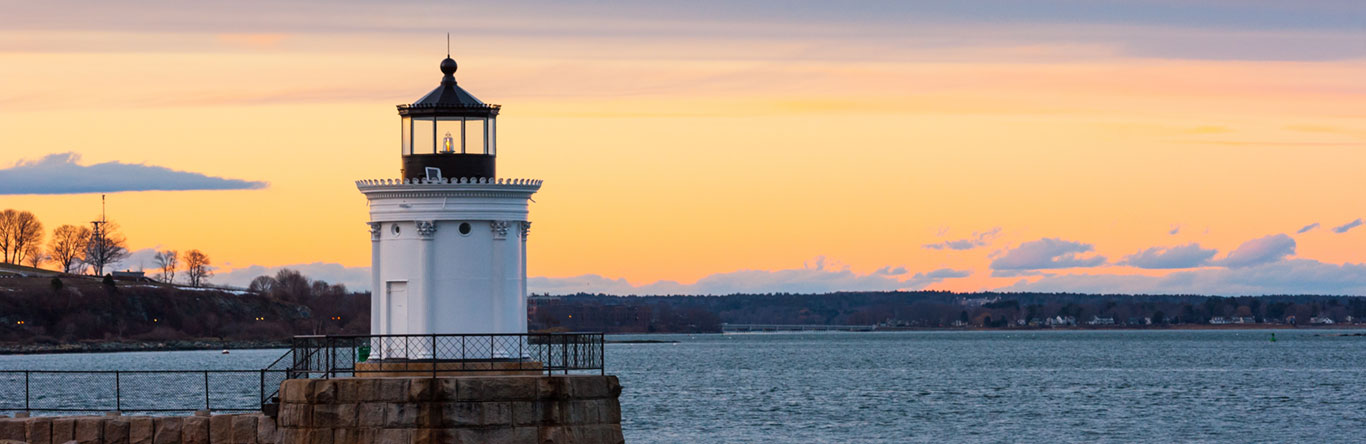 market street leadership lighthouse along coastline at dusk